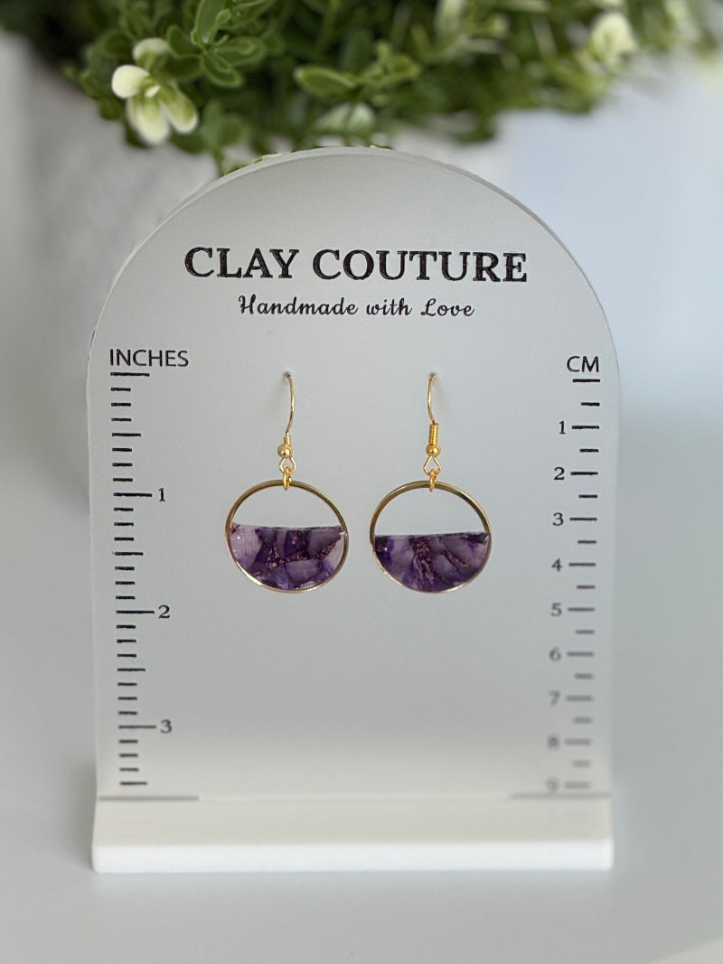 Amethyst and gold hoop earrings on a Clay Couture branded size stand