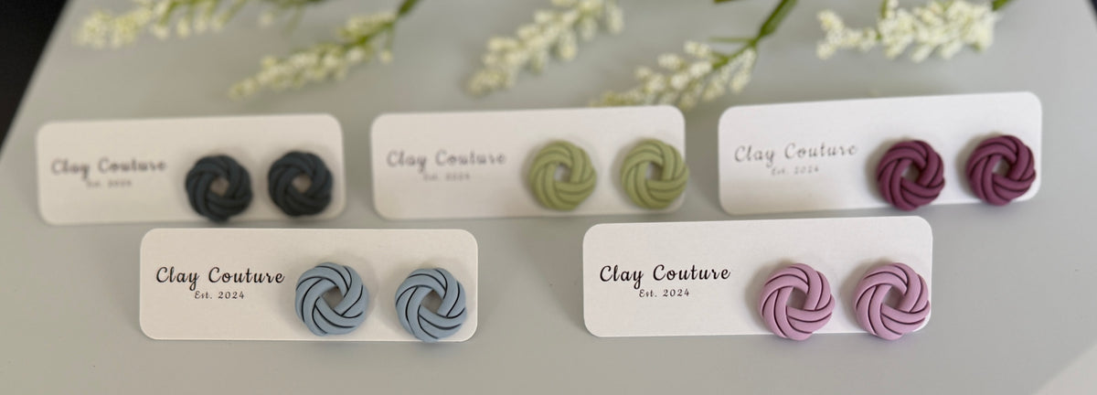 Set ofpolymer clay knot stud earrings on display with labels indicating brand and design.
